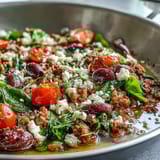 Steaming Mediterranean Keto Ground Chicken Skillet with Olives and Feta in a pan, featuring juicy ground chicken, vibrant cherry tomatoes, and briny Kalamata olives for a low-carb weeknight dinner.