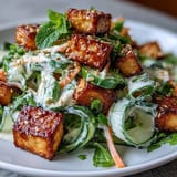 Savory, ultra-crispy tofu adds satisfying crunch to cool cucumbers and vibrant carrots in this Creamy Asian Cucumber Salad.
