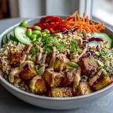 2. Wholesome peanut tofu power bowl featuring brown rice, fresh vegetables, and a rich, savory peanut dressing.  