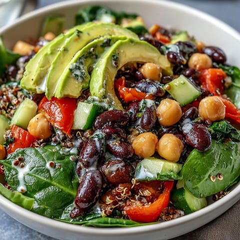 A vibrant Three-Bean Power Bowl topped with avocado and a lemony vinaigrette for a nourishing lunch.