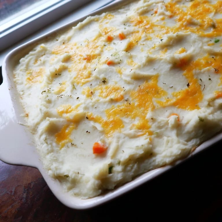 Homemade Shepherd's Pie, a classic comfort food casserole, is presented with a crispy potato top ready to serve.
