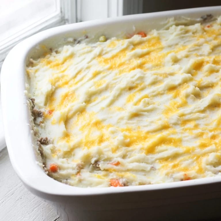 A close-up of a warm Shepherd's Pie reveals a hearty, comforting meal, perfect for a chilly evening.