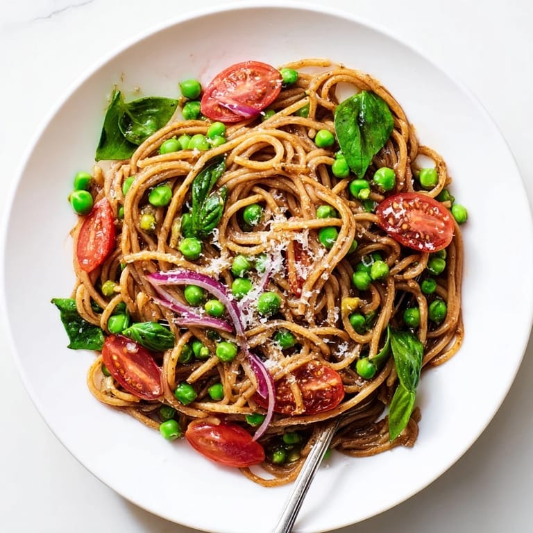 A close look at the Spring Veggie One-Pot Spaghetti, showcasing tender pasta coated in broth and piled with colorful, nutritious vegetables.
