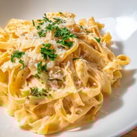 Creamy fettuccine in a sweet and spicy sriracha honey sauce, topped with fresh parsley and grated parmesan.  